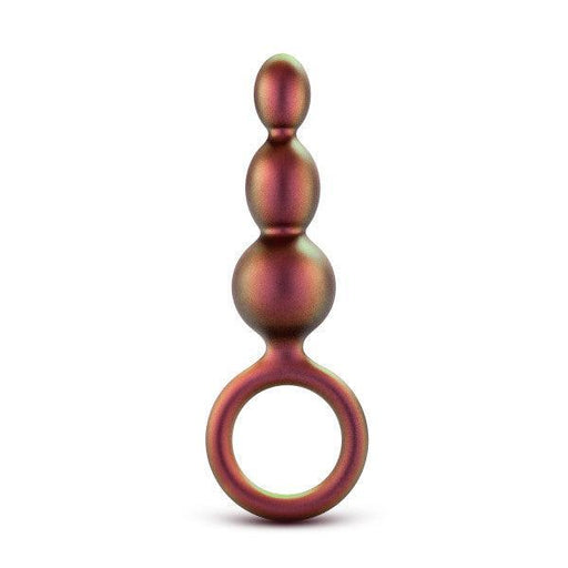 The Matrix First Time Soft Silicone Beaded Anal Beads with Finger Loop by Blush features three spherical segments of increasing size from top to bottom, resembling graduated beads. These metallic-toned, bulb-shaped beads have a smooth finish and come with a circular handle at the base for easy use and added control.