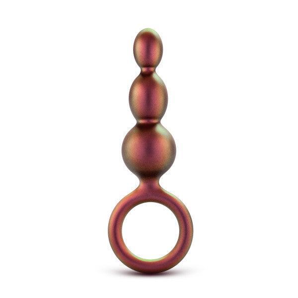 The Matrix First Time Soft Silicone Beaded Anal Beads with Finger Loop by Blush features three spherical segments of increasing size from top to bottom, resembling graduated beads. These metallic-toned, bulb-shaped beads have a smooth finish and come with a circular handle at the base for easy use and added control.
