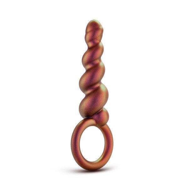 Introducing the Matrix First Time Soft Silicone Spiral Anal Beads with Finger Loop by Blush. This iridescent anal toy features a unique twisted spiral design and a convenient round finger loop at the base, perfect for orgasmic anal play. The colors elegantly shift between shades of green, gold, and bronze. The product is showcased standing upright against a white background.
