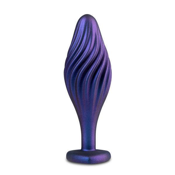 Introducing the Matrix Swirl Bling Butt Plug with Sparkly Heart Base by Blush: a sleek, dark purple metallic butt plug featuring a smooth, ribbed, and slightly curved design. Its heart-shaped flared base provides both safety and aesthetic appeal, ensuring it stays securely in place during use. The glossy finish highlights its minimalist yet sophisticated appearance.