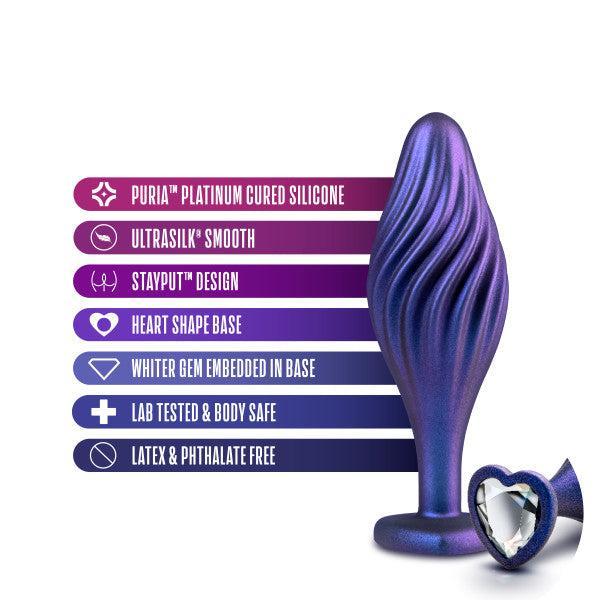 An image of the Matrix Swirl Bling Butt Plug with Sparkly Heart Base by Blush. This product features a stunning purple and blue swirl design, crafted from Puria Platinum Cured Silicone for an ultrasmooth feel. The StayPut Design ensures it remains securely in place, while the heart-shaped base is adorned with a sparkling white gem. Lab tested to be body-safe, this butt plug is also latex and phthalate-free.