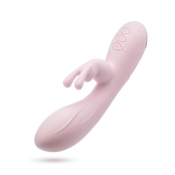 Introducing the Morgan Beginner G-Spot Rabbit Vibrator by Blush: a pink, sleek, and ergonomically designed vibrator featuring a rounded tip and a split attachment. Crafted from silky silicone, this device boasts dual motors and three buttons on the handle for precise control. Presented against a plain white background.
