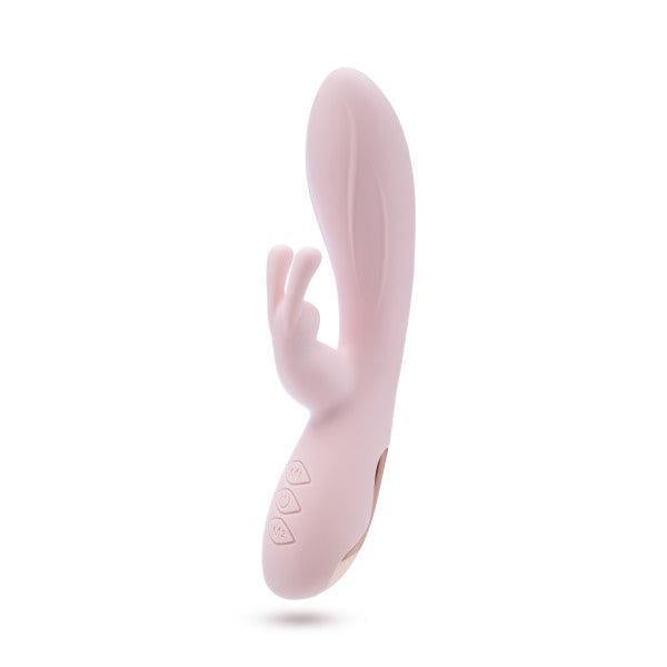 The Morgan Beginner G-Spot Rabbit Vibrator by Blush is a pink, silky silicone pleasure device, boasting two flexible ears and a contoured shaft. Equipped with dual motors for powerful sensations, the handle includes three control buttons for easy use. Its design ensures both internal and external stimulation elements are covered.