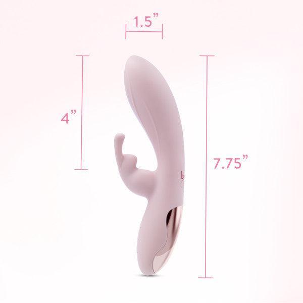 Introducing the Morgan Beginner G-Spot Rabbit Vibrator by Blush, a sleek and soft pink companion featuring both internal and external stimulation components. Crafted from silky silicone, it boasts a smooth, curved shape with dimensions of 1.5" in width, a 4" external part length, and a total length of 7.75". Enhanced by rose gold accents and dual motors for maximum pleasure.