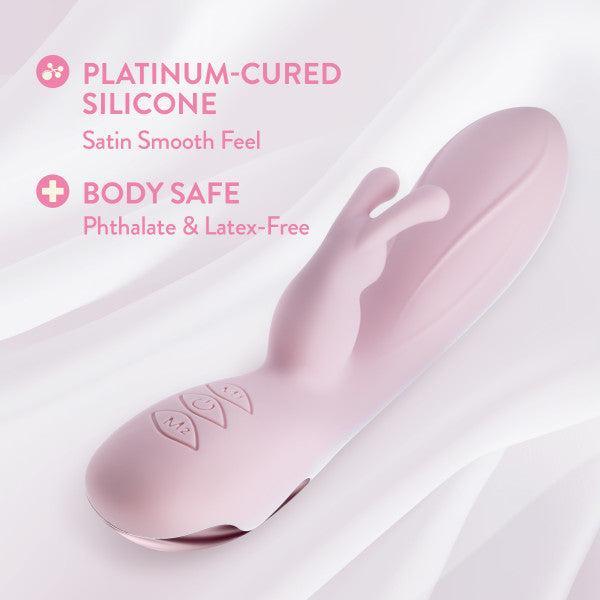The Morgan Beginner G-Spot Rabbit Vibrator by Blush is a soft pink silicone sex toy featuring a smooth, curved design and multiple control buttons. It is crafted from platinum-cured silicone, offering a satin smooth feel and ensuring body-safe use as it is phthalate and latex-free. This device is ideal for clitoral stimulation.