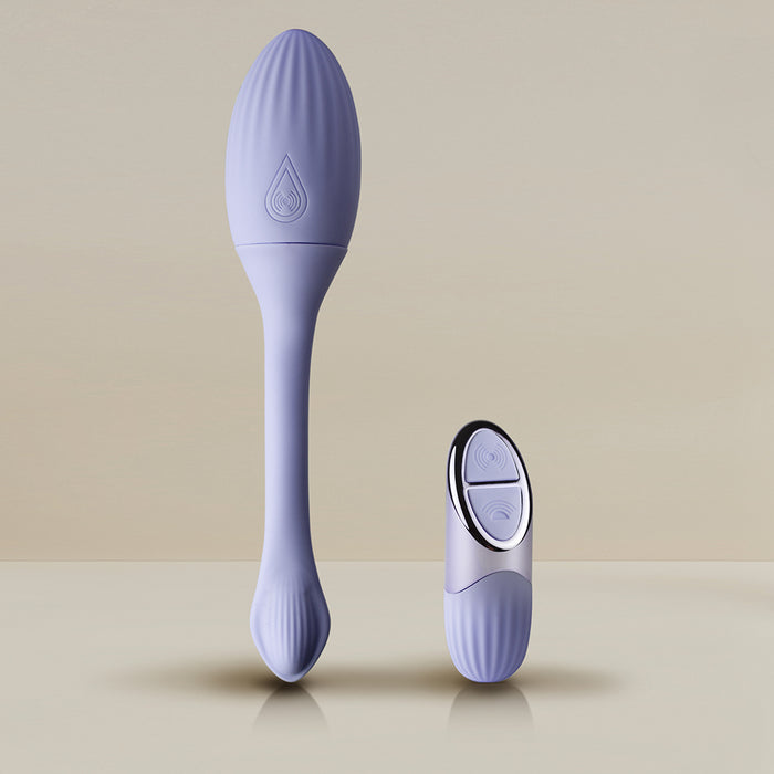 The Niya Rechargeable Kegel Exerciser and Vibrator with Remote, in lavender, stands upright beside its matching small oval-shaped two-button remote, both displayed on a neutral background.