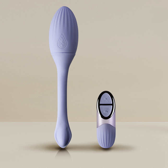 The Niya Rechargeable Kegel Exerciser and Vibrator with Remote, featuring a purple silicone textured oval head and long handle, is shown alongside its matching two-button wireless remote on a neutral background for pelvic floor strengthening.