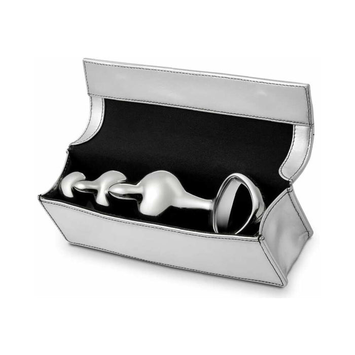 The Njoy Disco Weighted Stainless Steel Plug, a sleek metallic grey object with a handle, features a design of round sections for anal penetration and rests in an open box lined with silver satin. Expertly crafted from weighted stainless steel by the renowned brand Njoy, it offers an enhanced experience.