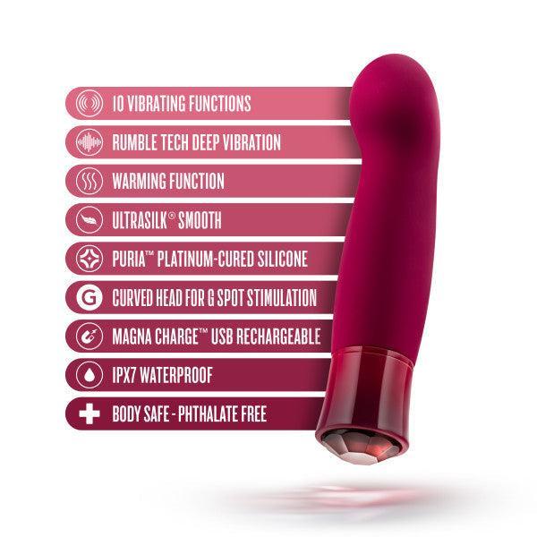 Introducing the Oh My Gem Classy Garnet Warming Internal & External Vibrator by Blush, a purple curved vibrator with a red base that boasts 10 vibrating functions to ignite sexual passion. This premium device features deep vibrations, an enticing warming function, smooth silicone for optimal G-spot stimulation, USB rechargeable capability, a waterproof design, and is crafted from body-safe materials.