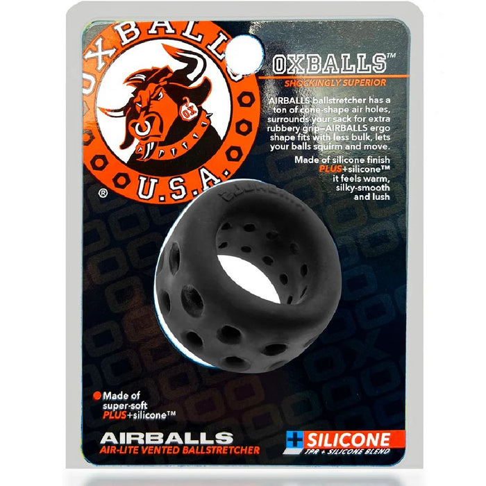 A product package with the brand "Oxballs" and logo featuring an ox. The package contains a black, perforated ring described as an Oxballs Air Lite Ventilated Ball Stretcher - Black Ice. Text highlights include "Made of super-soft silicone TPR blend," and "feels warm, silky-smooth, and lush.