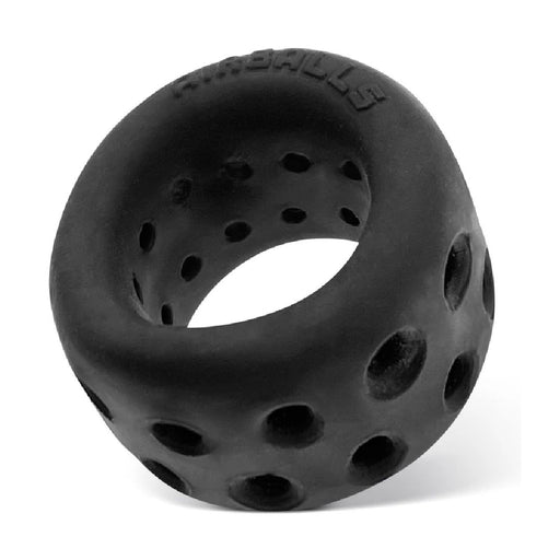 A black, round object resembling a toy ball, made of a silicone TPR blend with multiple small ventilation holes spread around its surface. The word "Oxballs" is embossed at the top edge. The background is plain white.

Product Name: Oxballs Air Lite Ventilated Ball Stretcher - Black Ice

Brand Name: Oxballs