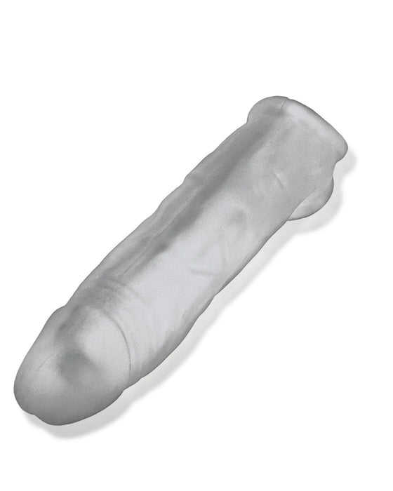 A transparent Oxballs Dicker 7.5 Inch Cock Sheath - Clear Ice shaped like a cylindrical tube with rounded ends. The sleeve appears flexible and is designed with a smooth surface, presumably for covering or protective purposes. The material looks soft and pliable, providing a slimmer fit sheath for various applications.
