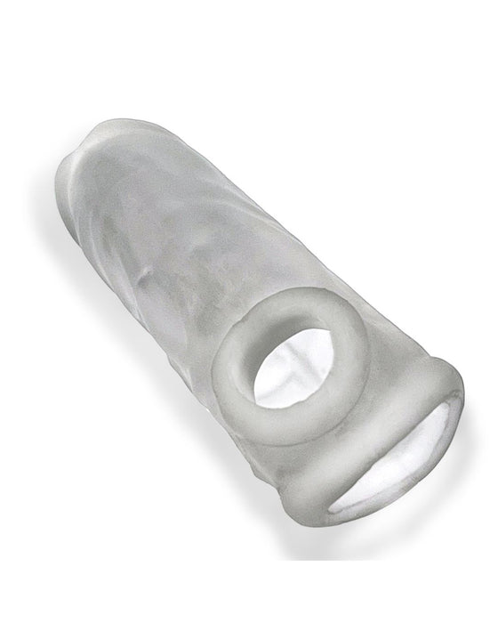 A transparent, cylindrical object with a ring at one end, likely an Oxballs Dicker 7.5 Inch Cock Sheath - Clear Ice made from Plus+SILICONE. The material appears to be flexible and is placed on a plain, white surface. Its purpose is not immediately clear from the image.