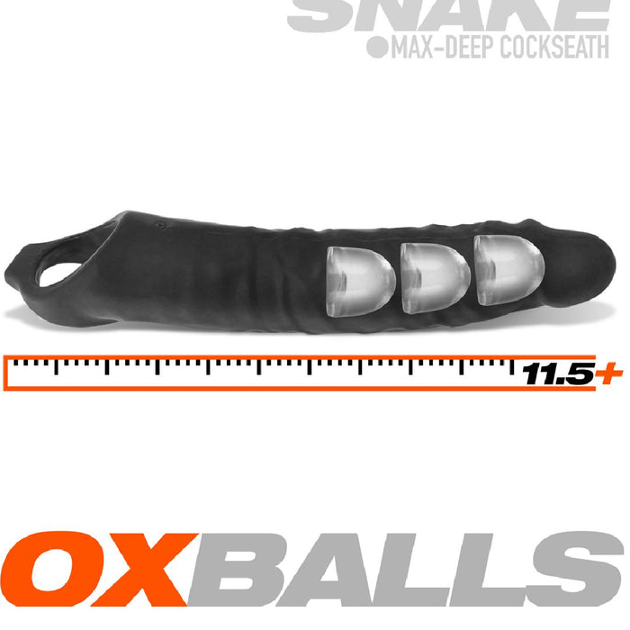 An extended black silicone sheath with a veiny texture and three clear, bulbous segments. A ruler on the side marks its length as over 11.5 inches. Text reads, "Oxballs" and "Snake Extra Long 11 Inch Cock Sheath with Ball Strap." Enjoy an adjustable fit for ultimate comfort in this ultra-long cock sheath.