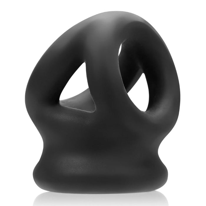 Representing a modern and artistic design, the Oxballs Tri Squeeze Cocksling Ball Stretcher - Black by Oxballs is a body-safe, matte black silicone accessory that features multiple openings and rounded edges, resembling a small, futuristic sculpture.