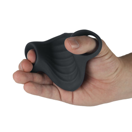 A hand holds the Palm Vibrating Versatile & Accessible Masturbator, a black, textured device made of body-safe silicone with a curved shape and a circular opening at one end.