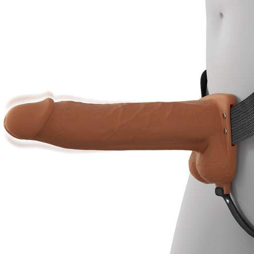 A person wears the Fantasy X-Tensions Elite Vibrating Hollow 8 Inch Silicone Dildo & Strap-On Harness in Chocolate, shown from the side against a plain background.
