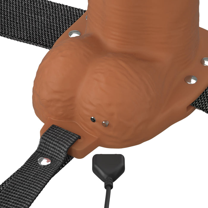 A close-up of the Fantasy X-Tensions Elite Vibrating Hollow 8 Inch Silicone Dildo & Strap-On Harness in Chocolate, featuring a realistic dildo, adjustable black strap, and a small black connector at the base.