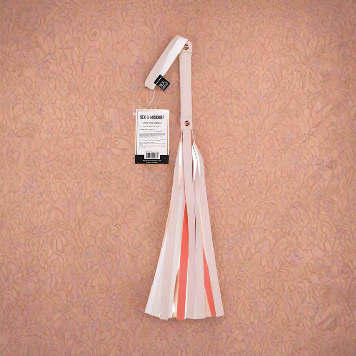 The Peaches 'n Cream Flogger by Sportsheets features a lively combination of pink and white faux leather strands, complemented by a chic tag on the handle.