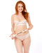 A woman with long red hair, dressed in a sheer white bra and beige underwear, stands smiling against a white background while holding the Peaches 'n Cream Impressions Crop featuring a playful plastic hand at the tip.