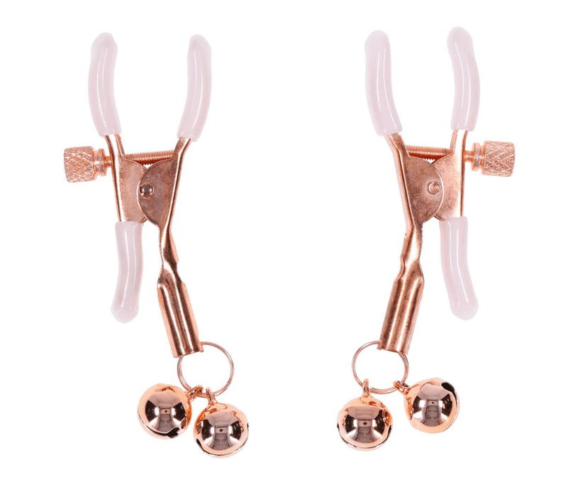 The Peaches 'n Cream Pearl Nipple Clamps with Bells are gold-colored, adjustable clamps with white silicone tips and small gold jingle bells, shown on a white background.