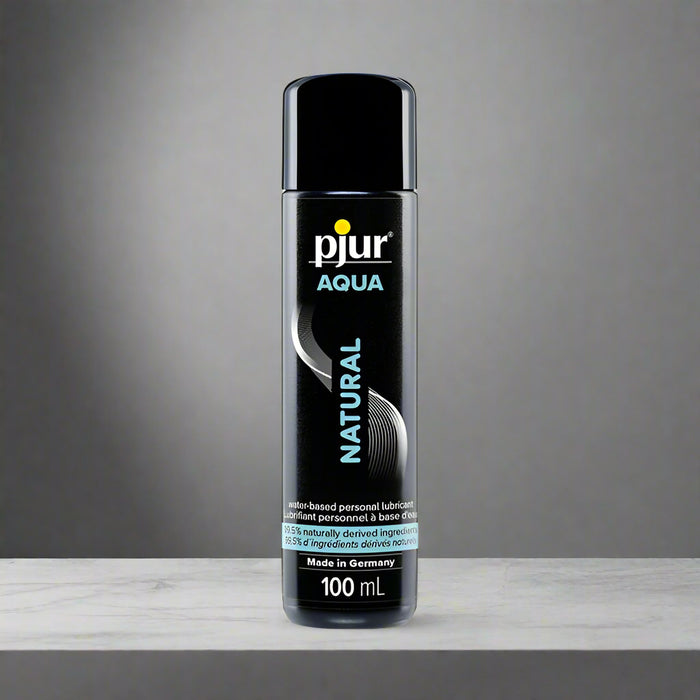 The 3.4 oz Pjur Aqua Natural Water-Based Personal Lubricant comes in a black bottle with a white and teal label, highlighting its moisturizing, biocompatible formula. This lubricant is water-based and made in Germany.