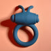 A blue Playboy Bunny Buzzer Vibrating Silicone Cock Ring, made from body-safe silicone with two short bunny ear-like protrusions and a subtle bunny logo, is shown on a peach-colored background.
