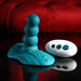 The Playboy Have a Seat Remote Control Grinding Vibrator Pad, made from body-safe silicone with a beaded shaft and textured suction cup base, is displayed next to its white remote on a glossy black surface against a red velvet backdrop.