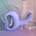 The Playboy Nice to Meet You Powerful Thrusting Vibrator with Handle in purple rests on a table.