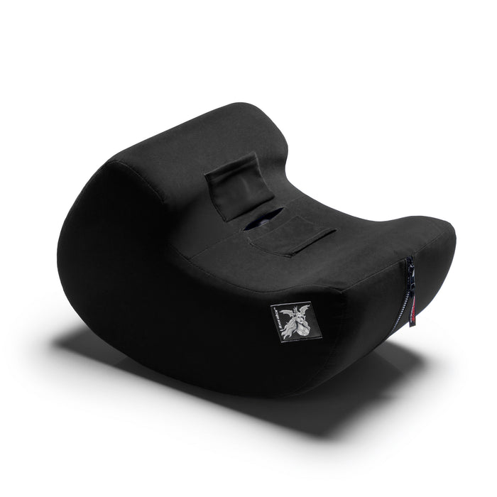 The Liberator Pulse – Ergonomic Straddling Toy Mount is a black, curved pillow with a small side zipper and a white embroidered logo patch on the front, inspired by Liberator furniture and displayed on a white background.