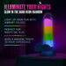 A Rainbow Rave Glow in the Dark 6.5 Inch Silicone Dildo from Blush is showcased on a table, radiating bright colors in the dark. Text on the image emphasizes its features: illuminating nights, vibrant colors, and enhancing nighttime experiences with a realistic feel.