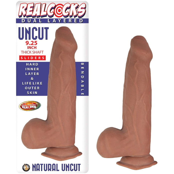 Image of a realistic, dual-layered, bendable adult toy from the brand Nasstoys. The Realcocks Uncut 9.25" Slider Dildo with Thick Shaft & Sliding Skin - Chocolate features a thick shaft with a hard inner layer and lifelike outer skin. Equipped with a suction cup base and strap-on harness compatibility, the packaging highlights "Natural Uncut" and includes a "Real Skin" emblem.