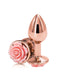 A pair of Rear Assets Rose Gold Metal Butt Plugs with Pink Rose by NS Novelties, one standing upright and the other lying down. Each plug features a delicate pink rose design at the base, perfect for temperature play.