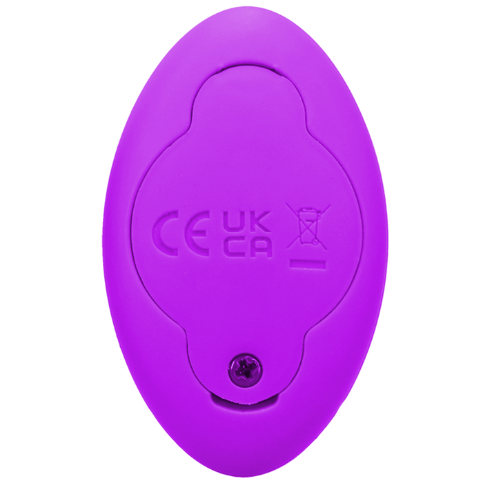 A close-up of the Remote Controlled Panty Vibrator for Beginners in a Bag by Doc Johnson, showcasing its small, oval-shaped purple design and regulatory compliance symbols on its backside, including CE and UKCA markings along with a crossed-out wheeled bin icon. A screw at the bottom highlights its eco-friendly assembly.