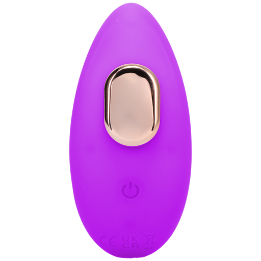 A small, oval-shaped, purple Remote Controlled Panty Vibrator for Beginners in a Bag by Doc Johnson, featuring a gold button on top and a power symbol near the bottom. The device appears to be made of a smooth, soft material and has an eco-friendly design.