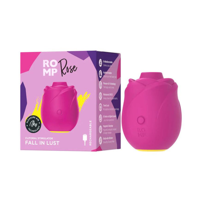 The Romp Rose 2 Pleasure Air Clitoris Stimulator, shaped like a pink rose, is shown beside its vibrant box labeled "ROMP Rose" and featuring the slogan "FALL IN LUST" for enhanced clitoral stimulation.