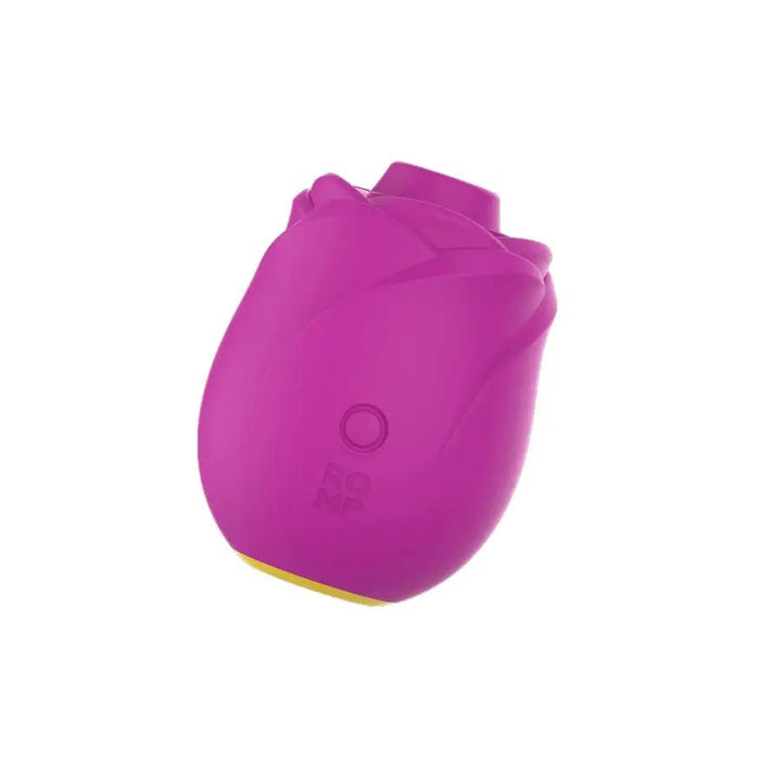 The Romp Rose 2 Pleasure Air Clitoris Stimulator is a small, pink silicone device shaped like a rose with "ROMP" on its side, featuring a button for clitoral stimulation. The product is set against a white background.