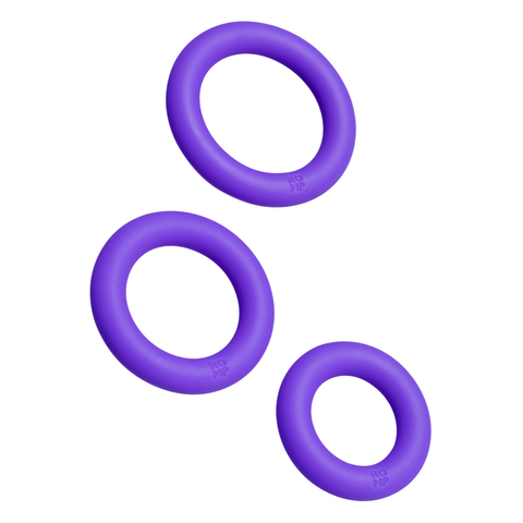 The Romp Remix Cock Ring Trio, made from body-safe silicone, features three purple rings in different sizes displayed on a white background.