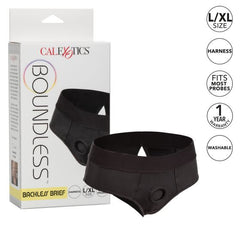 Boundless Backless Strap-on Harness Brief - S/M by CalExotics, displayed alongside its packaging, featuring size and brand information. This comfortable harness is machine washable, ensuring easy care.