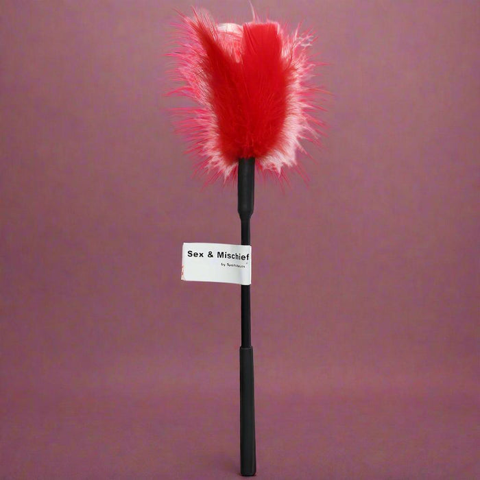 The Sex and Mischief 7" Feather Tickler by Sportsheets features a red feather with a black handle and a label that reads "Sex & Mischief".