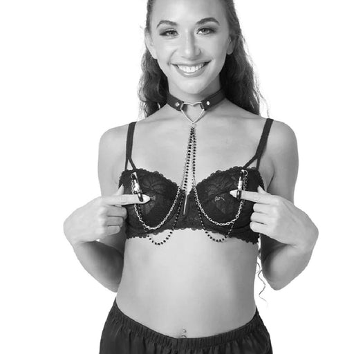 Black and white photo of model wearing Sex & Mischief Amor Heart Collar and Nipple Jewelry