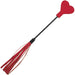 The Sex & Mischief Amor Red Heart Crop and Flogger features multiple red faux leather tails and a heart-shaped tip, making this portable sex toy stand out against a white background.