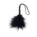 The Sex & Mischief Black Wrist Feather Tickler features a fluffy black feather end, compact handle, and looped strap—ideal for sensory play and a chic addition to your black accessories. Shown isolated on a white background.
