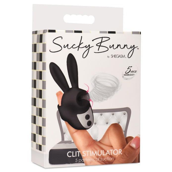 The image showcases the packaging of a product called "Shegasm Sucky Bunny Beginner Clit Stimulator" by XR Brands. This clit stimulator, crafted from body-safe silicone, provides five patterns of clitoral suction. The box features an image of the toy, shaped like a small bunny, being held on a person's finger and includes a 5-year warranty.