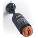 A Pipedream Products 'Shower Therapy Discreet Realistic Stroker with Mount - Caramel' is securely attached to a tiled wall using its suction cup mount. The upright bottle, labeled with the product name, features a realistic stroker made of Fanta Flesh TPE material at the opening.