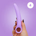 A hand with dark nail polish holds the Skins Care Curved Vaginal Dilators 3-Piece Set (Medium/Large), made of light purple medical-grade silicone with a circular handle, against a purple background. A white circle with the number 4 is in the upper right corner.