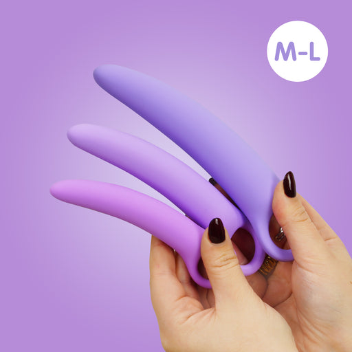 A person with dark painted nails holds the Skins Care Curved Vaginal Dilators 3-Piece Set (Medium/Large), made of medical-grade silicone, against a purple background. A white circle in the corner reads "M-L.