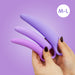 A person with dark painted nails holds the Skins Care Curved Vaginal Dilators 3-Piece Set (Medium/Large), made of medical-grade silicone, against a purple background. A white circle in the corner reads "M-L.