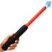A hand holds the Spark Rod Electro Stimulation Zapping Wand, a black and red device with a blue electric spark at the tip, indicating the wand is turned on.