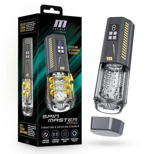 A sleek black box featuring an image of the Spin Master Pro Vibrating, Stroking, Rotating, Automatic Stroker from Blush is displayed. Next to the box sits the masturbator device, highlighting its clear textured chamber, various vibration settings, and a digital screen on its handle. The removed cap rests beside it.